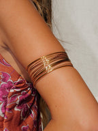 Adriana | Brazalete de aros cruzados dorado